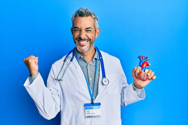 Homem Cabelos Grisalhos Meia Idade Usando Uniforme Médico Segurando Coração — Fotografia de Stock