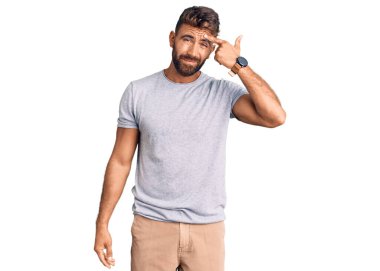 Alnındaki sivilceden mutsuz olduğunu gösteren günlük kıyafetler giyen genç İspanyol adam, siyah başlıklı çirkin enfeksiyon. sivilce ve deri problemi 