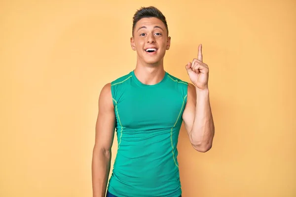 Young Hispanic Boy Wearing Sporty Style Sleeveless Shirt Pointing Finger — Stock fotografie