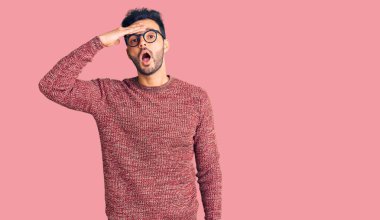 Kış süveteri giyen ve gözlük takan yakışıklı genç bir adam hata sonucu kafasının üstünde şaşırmış. Hatayı hatırla. Unuttum, kötü hafıza kavramı. 