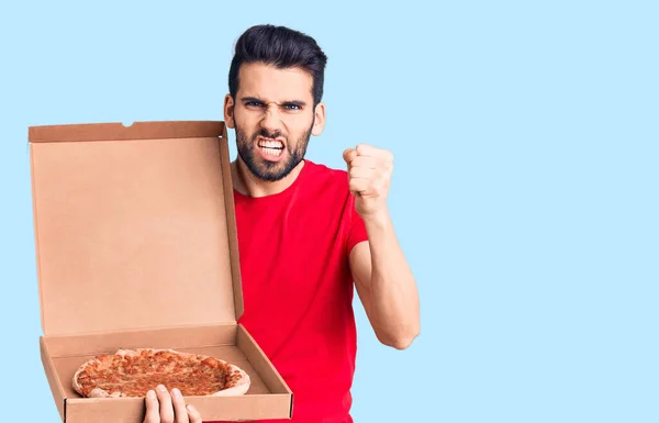 Young Handsome Man Beard Holding Delivery Cardboard Italian Pizza Annoyed — Stock Photo, Image