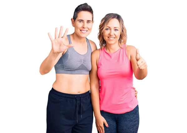 Couple Women Wearing Sportswear Showing Pointing Fingers Number Six While — Stock Photo, Image