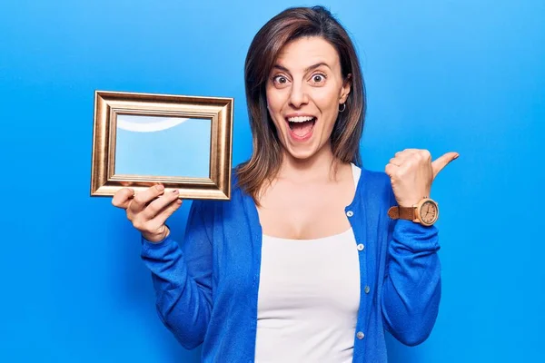 Jong Mooi Vrouw Houden Leeg Frame Wijzen Duim Naar Zijkant — Stockfoto