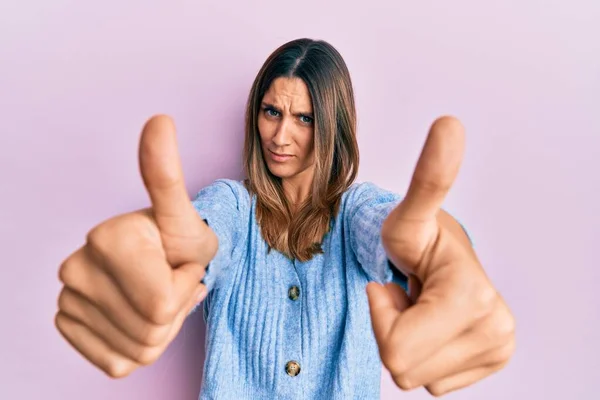 Brunette Young Woman Doing Thumbs Positive Gesture Skeptic Nervous Frowning — Stock Photo, Image