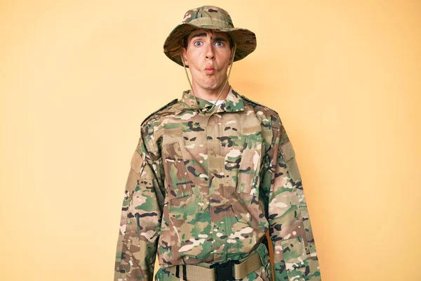 Young Handsome Man Wearing Camouflage Army Uniform Making Fish Face — Stock Photo, Image