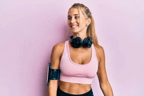 Ung Blond Kvinna Bär Gym Kläder Och Använder Hörlurar Tittar — Stockfoto
