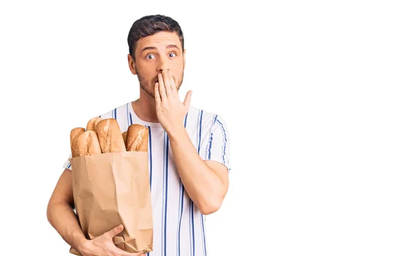 Handsome Young Man Bear Holding Paper Bag Bread Covering Mouth — Stock fotografie