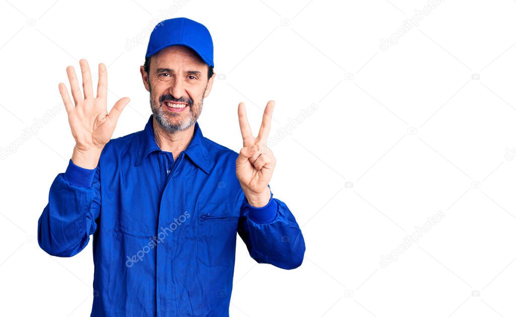 Middle age handsome man wearing mechanic uniform showing and pointing up with fingers number seven while smiling confident and happy. 