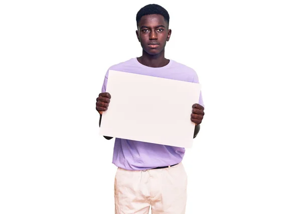 Young African American Man Holding Blank Empty Banner Thinking Attitude — Stock Photo, Image