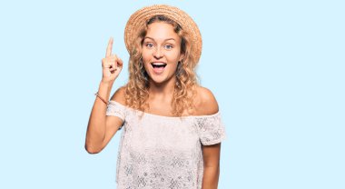 Yazlık şapkalı güzel beyaz kadın başarılı bir fikirle işaret ediyor. Heyecanlı ve mutlu. Bir numara.. 