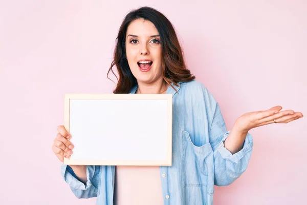 Young Beautiful Brunette Woman Holding Blank Empty Banner Celebrating Achievement — Stock Photo, Image