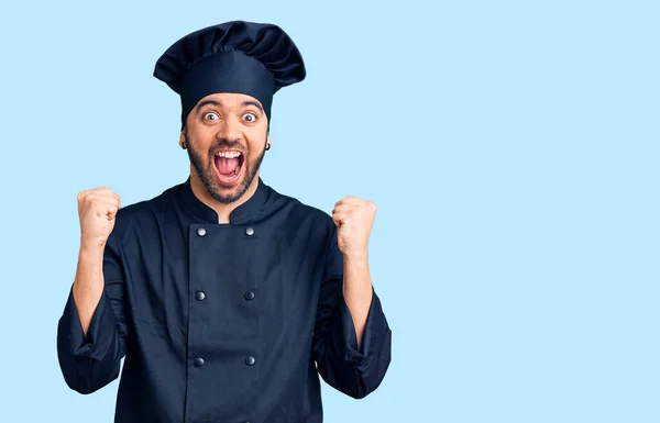 Young Hispanic Man Wearing Cooker Uniform Celebrating Surprised Amazed Success — Stock Photo, Image