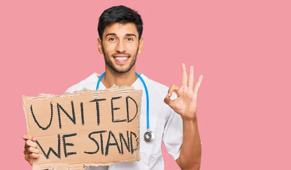 Young Handsome Man Wearing Doctor Uniform Holding United Stand Banner — Stock Photo, Image