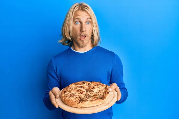 Kaukasischer Junger Mann Mit Langen Haaren Hält Italienische Pizza Schockgesicht — Stockfoto