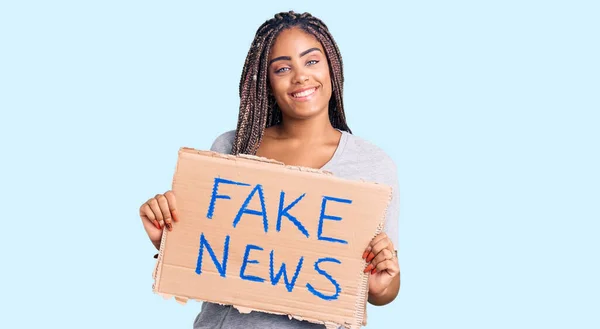 Young African American Woman Braids Holding Fake News Banner Looking — Stock fotografie