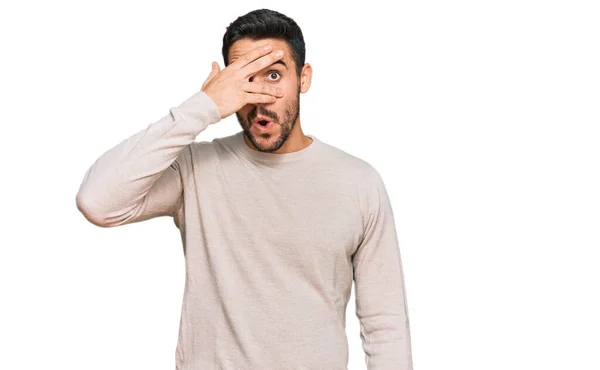 Young Hispanic Man Wearing Casual Clothes Peeking Shock Covering Face — Stock Photo, Image