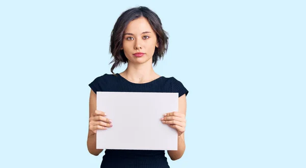 Young Beautiful Girl Holding Blank Empty Banner Thinking Attitude Sober — Stock Photo, Image