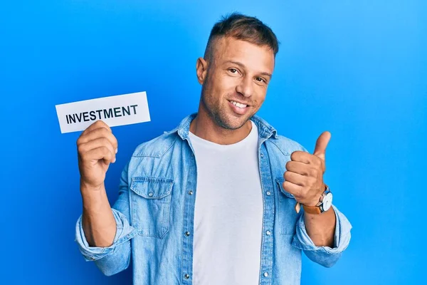 Handsome Muscle Man Holding Investment Word Paper Smiling Happy Positive — Stock Photo, Image