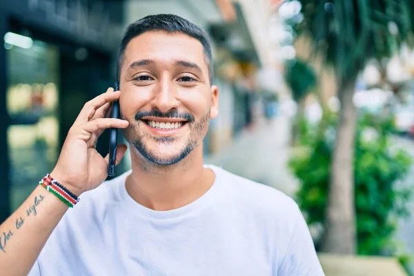 Ung Latinamerikansk Man Ler Glad Talar Smartphone Gatan Staden — Stockfoto