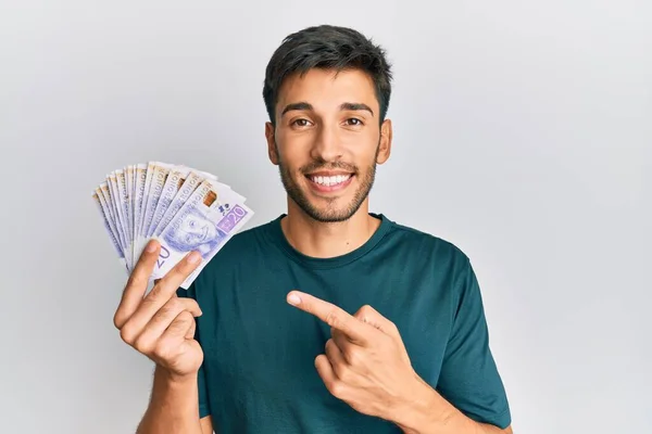 Junger Gutaussehender Mann Hält Schwedische Kronen Banknoten Und Lächelt Glücklich — Stockfoto