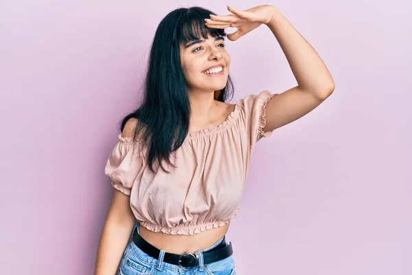 若いヒスパニック系の女の子は非常に幸せと笑みを浮かべて離れて手を頭の上に見てカジュアルな服を着て 検索の概念 — ストック写真