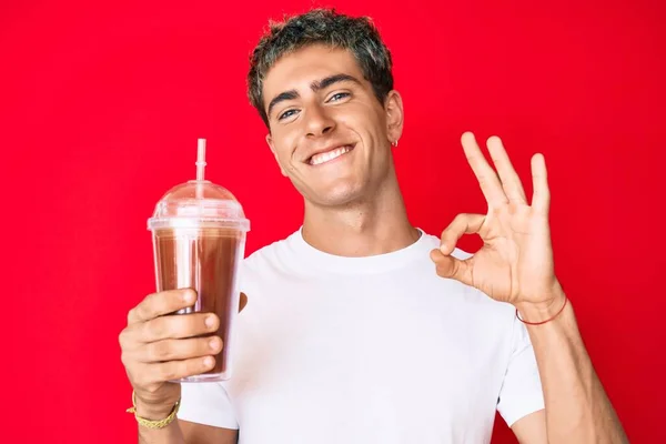 Young Handsome Man Holding Glass Smoothie Doing Sign Fingers Smiling — Stok fotoğraf