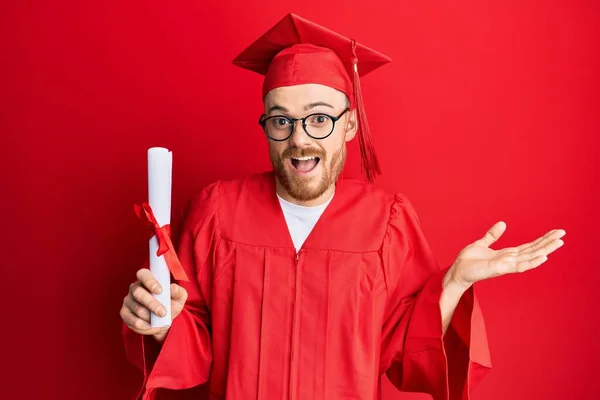 Young Redhead Man Wearing Graduation Cap Ceremony Robe Holding Degree — Foto de Stock