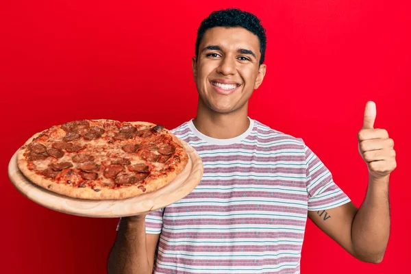 Young Arab Man Holding Italian Pizza Smiling Happy Positive Thumb — Stock Photo, Image