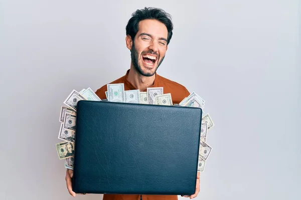 Young Hispanic Man Holding Briefcase Dollars Smiling Laughing Hard Out — Stock Photo, Image