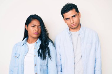 Gündelik giysiler giyen, kuşkucu ve gergin, sorun yüzünden surat asan güzel Latin bir çift. negatif kişi. 