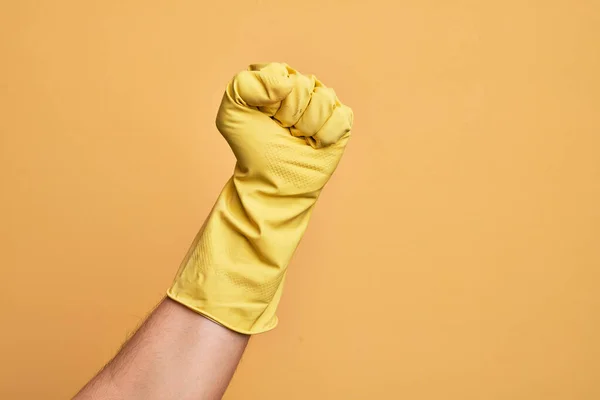 Hand Caucasian Young Man Cleaning Glove Isolated Yellow Background Doing — Stock Photo, Image