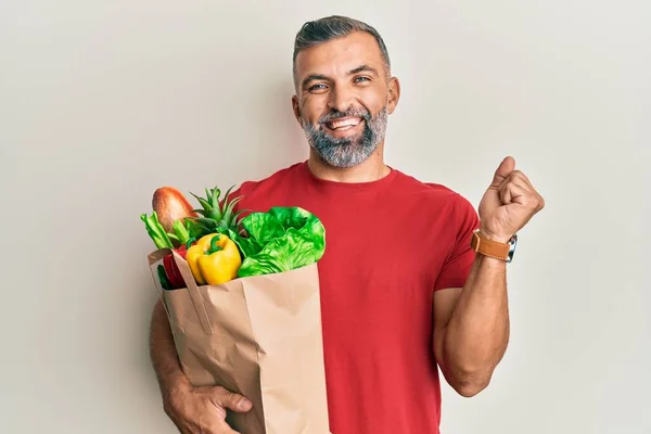 Middle Age Handsome Man Holding Paper Bag Bread Groceries Screaming —  Fotos de Stock