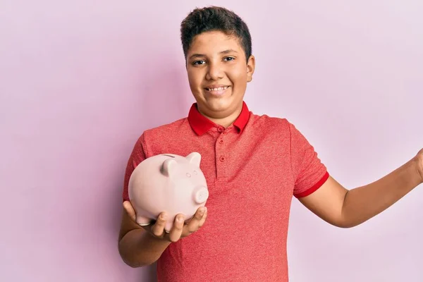 Teenager Hispánský Chlapec Drží Prasátko Banka Slaví Úspěch Veselým Úsměvem — Stock fotografie