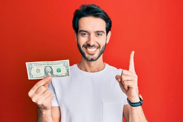 Young Hispanic Man Holding Dollar Banknote Smiling Idea Question Pointing — Stock Photo, Image