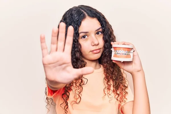 Hermosa Niña Con Pelo Rizado Ortodoncia Celebración Con Mano Abierta — Foto de Stock