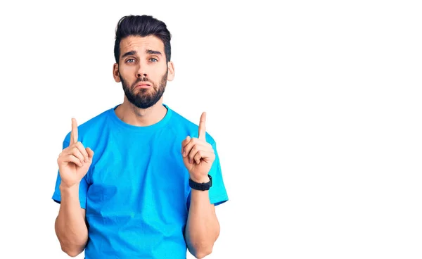 Pemuda Tampan Dengan Jenggot Mengenakan Kaos Kasual Menunjuk Atas Tampak — Stok Foto
