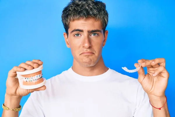 Young Handsome Man Holding Orthodontic Depressed Worry Distress Crying Angry — Stock fotografie