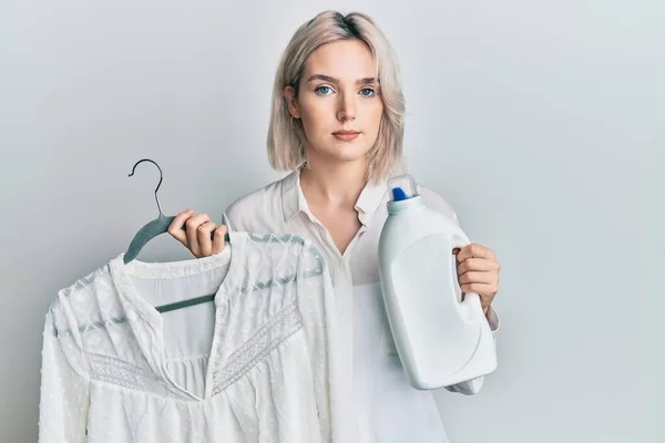 Young Blonde Girl Holding Detergent Bottle Shirt Relaxed Serious Expression — 图库照片