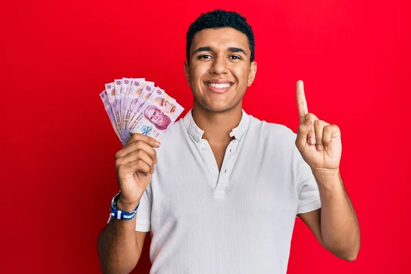 Young Arab Man Holding Mexican Pesos Smiling Idea Question Pointing —  Fotos de Stock