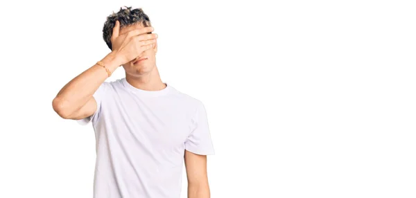 Young Handsome Man Wearing Casual White Tshirt Covering Eyes Hand — Zdjęcie stockowe