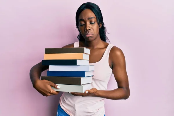 Young African American Woman Holding Books Depressed Worry Distress Crying — Stockfoto
