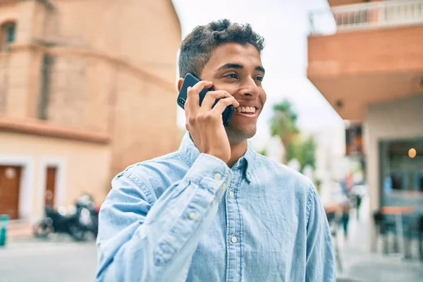 Junger Lateinischer Mann Lächelt Glücklich Und Spricht Auf Dem Smartphone — Stockfoto