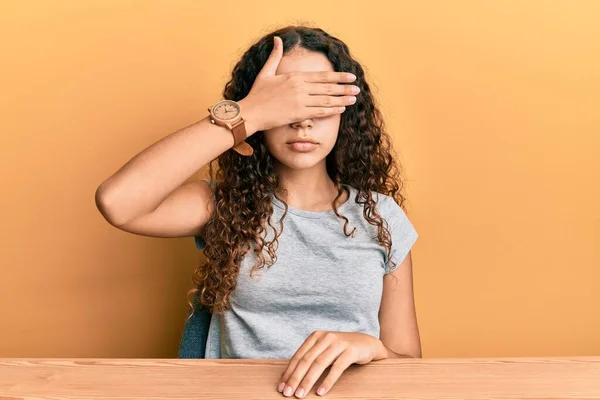 Teenager Hispanic Girl Wearing Casual Clothes Sitting Table Covering Eyes — Stockfoto