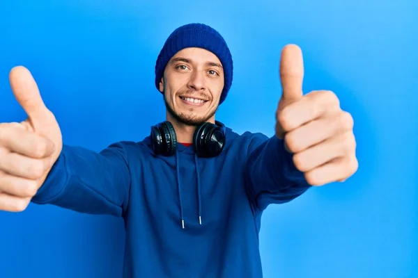 Hispanic Young Man Wearing Sweatshirt Headphones Approving Doing Positive Gesture — Stock Photo, Image