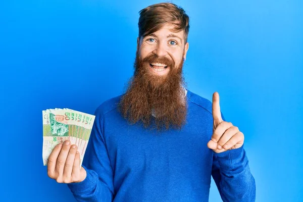 Young Irish Redhead Man Holding Hong Kong Dollars Banknotes Smiling — Stock Photo, Image