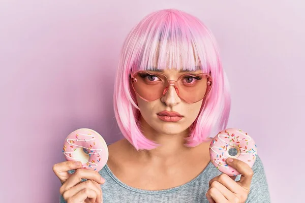 Young Caucasian Woman Wearing Pink Wig Holding Donuts Depressed Worry — Stockfoto