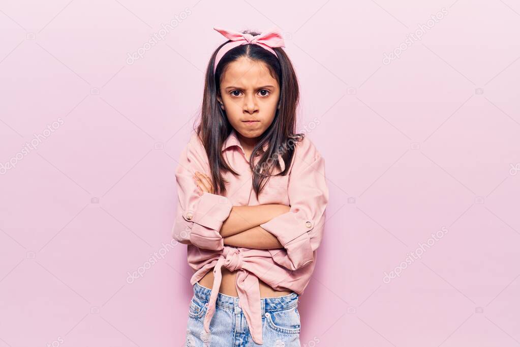 Beautiful child girl wearing casual clothes skeptic and nervous, disapproving expression on face with crossed arms. negative person. 