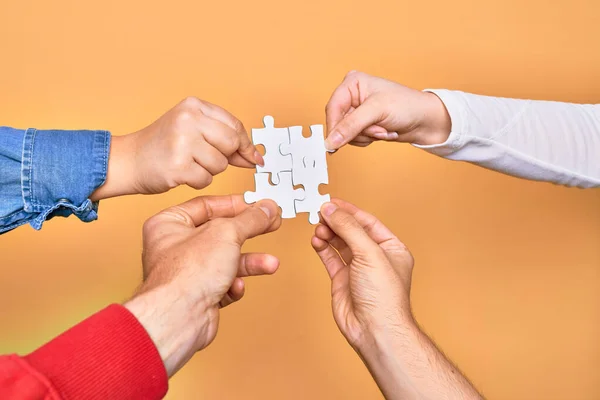 Mani Giovani Caucasici Che Collegano Pezzi Puzzle Sfondo Giallo Isolato — Foto Stock