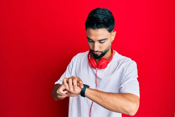 Young Man Beard Listening Music Using Headphones Checking Time Wrist — Stockfoto