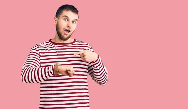 Young Handsome Man Wearing Striped Sweater Hurry Pointing Watch Time — Stock Photo, Image